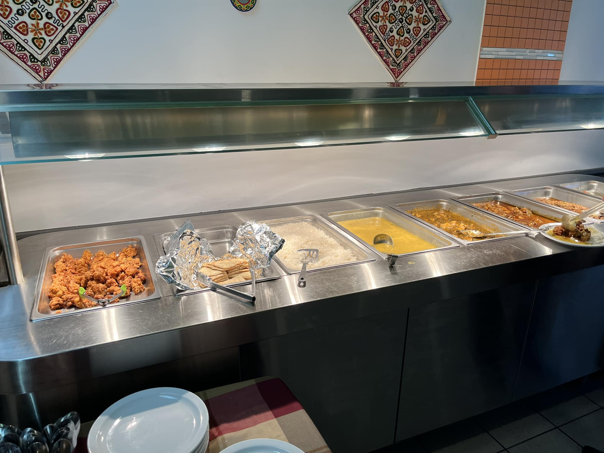 Desi Meal lunch buffet steam table with pakoras, naan, basmati rice, daal and curries